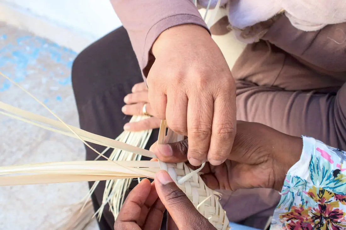 two people are working on a piece of art