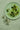 A plate of green olives on a table