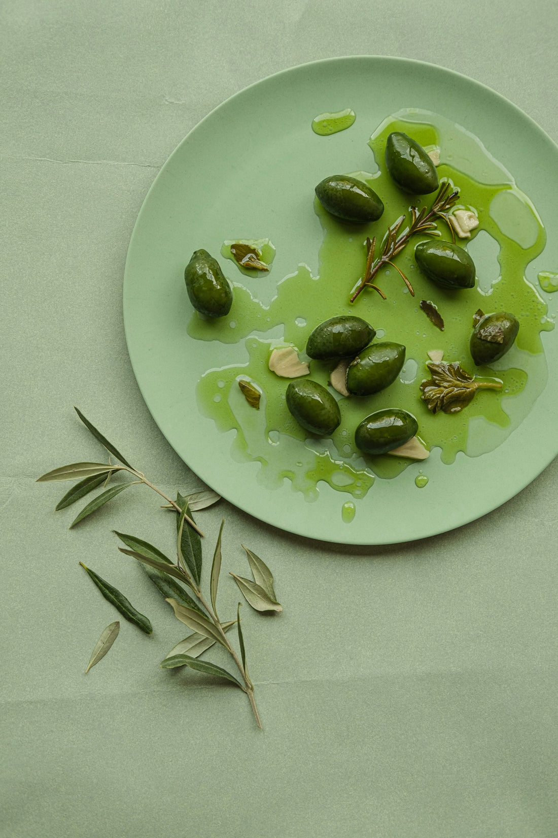 A plate of green olives on a table