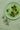 A plate of green olives on a table
