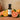 Orange White Balsamic Vinegar bottle with fresh oranges on terracotta surface