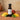 Jalapeno Mango White Balsamic Vinegar bottle with mango and jalapeños on terracotta surface