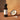 Coconut Aged White Balsamic Vinegar bottle with coconut on terracotta surface