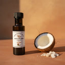 Coconut Aged White Balsamic Vinegar bottle with coconut on terracotta surface