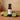Kiwi White Balsamic Vinegar bottle with fresh kiwi on terracotta surface