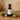 Jalapeno White Balsamic Vinegar bottle with fresh jalapeños on terracotta surface