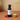 Honey Raspberry Dark Balsamic Vinegar bottle with raspberries and honeycomb on terracotta surface