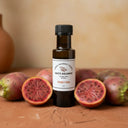 Prickly Pear White Balsamic Vinegar bottle with prickly pear cactus fruit on terracotta surface