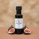 Fig White Balsamic Vinegar bottle with fresh figs on terracotta surface