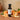 Tangerine Aged White Balsamic Vinegar bottle with fresh tangerines on terracotta surface