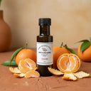 Tangerine Aged White Balsamic Vinegar bottle with fresh tangerines on terracotta surface