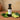Jalapeno Lime White Balsamic Vinegar bottle with jalapeños and lime on terracotta surface