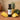 Pineapple White Balsamic Vinegar bottle with fresh pineapple on terracotta surface
