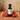 Watermelon Strawberry White Balsamic Vinegar bottle with watermelon and strawberries on terracotta surface