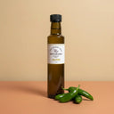 Jalapeno Aged White Balsamic Vinegar 250ml bottle on warm terracotta surface