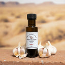 Garlic White Balsamic Vinegar bottle with garlic bulbs on terracotta surface