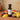 Tropical Passion White Balsamic Vinegar bottle with passion fruit and mango on terracotta surface