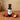 Strawberry White Balsamic Vinegar bottle with fresh strawberries on terracotta surface