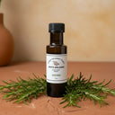 Rosemary White Balsamic Vinegar bottle with fresh rosemary sprigs on terracotta surface