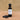 Acai Berry White Balsamic Vinegar bottle with acai berries on terracotta surface