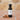 Butter Pecan White Balsamic Vinegar bottle with pecans on terracotta surface