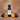 Apricot Plum White Balsamic Vinegar bottle with apricots and plums on terracotta surface