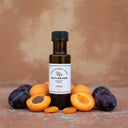Apricot Plum White Balsamic Vinegar bottle with apricots and plums on terracotta surface