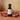 Pomegranate White Balsamic Vinegar bottle with fresh pomegranate on terracotta surface
