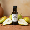Pear White Balsamic Vinegar bottle with fresh pears on terracotta surface