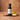 Cranberry Pear White Balsamic Vinegar bottle with cranberries and pear on terracotta surface