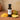 Mango White Balsamic Vinegar bottle with fresh mango on terracotta surface