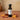 Maple White Balsamic Vinegar bottle with maple syrup and maple leaves on terracotta surface
