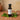 Green Tea White Balsamic Vinegar bottle with green tea leaves on terracotta surface