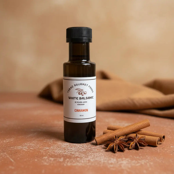 Cinnamon White Balsamic Vinegar bottle with cinnamon sticks on terracotta surface
