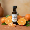 Mandarin Orange White Balsamic Vinegar bottle with fresh mandarin oranges on terracotta surface