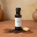 Tiramisu White Balsamic Vinegar bottle with espresso beans and cocoa on terracotta surface