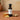 Honey Ginger White Balsamic Vinegar bottle with ginger and honeycomb on terracotta surface