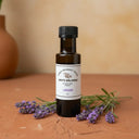Lavender White Balsamic Vinegar bottle with fresh lavender sprigs on terracotta surface