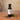 Smoked White Balsamic Vinegar bottle with wood chips on terracotta surface