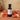 Watermelon White Balsamic Vinegar bottle with fresh watermelon on terracotta surface